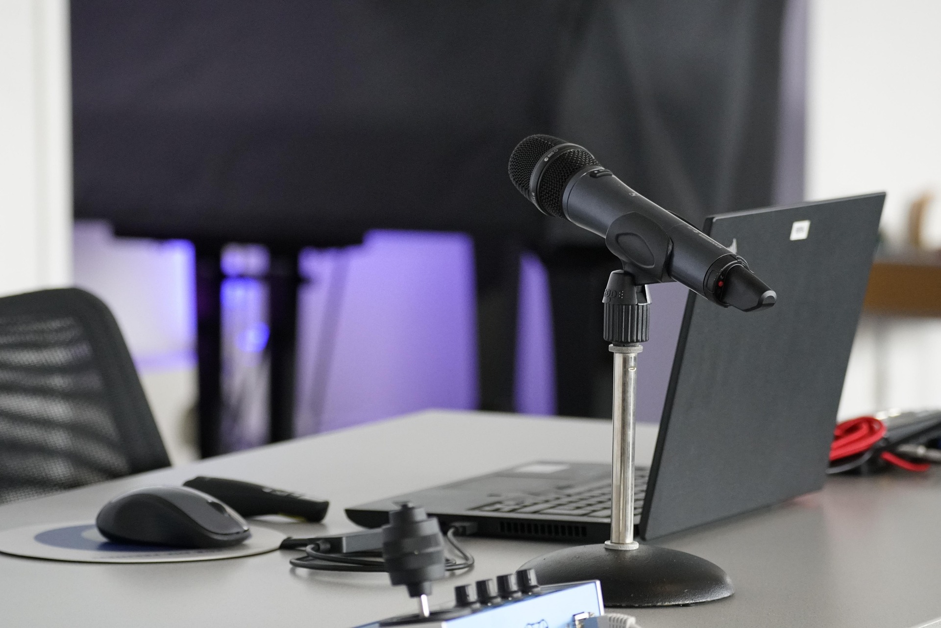 A microphone and a laptop on a table
